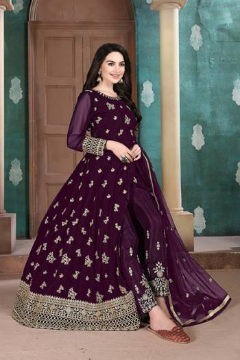 Here Is A Very Pretty Heavy Designer Indo-Western Suit In Dark Wine Color. Its Emnbroidred Floor Length To Is Fabricated On Georgette Paired With Embroidered Bottom Fabricated On Santoon and Net Fabricated Dupatta. 