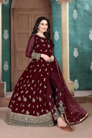 Here Is A Very Pretty Heavy Designer Indo-Western Suit In Maroon Color. Its Emnbroidred Floor Length To Is Fabricated On Georgette Paired With Embroidered Bottom Fabricated On Santoon and Net Fabricated Dupatta. 