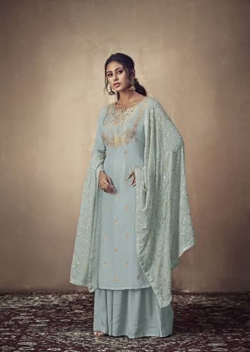 Here Is A Rich And Elegant Looking Designer Straight Suit In Dusty Blue Color. Its Elegant Top Is Fabricated On Banarasi Jacquard Paired With Satin Bottom And Georgette Fabricated Lakhnavi Embroidered Dupatta. Its Subtle Tone To Tone Embroidery Gives Rich And Elegant Look To Your Personality. 