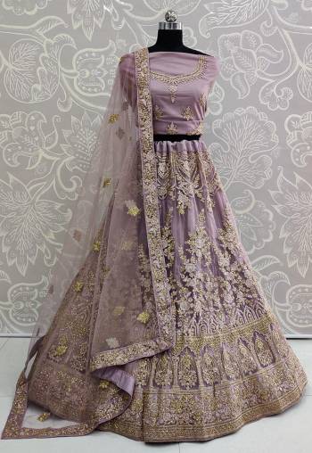 You Will Definitely Earn Lots Of Compliments Wearing This Designer Trendy Lehenga Choli In Mauve Color. Its Blouse, Lehenga And Dupatta Are Fabricated On Net Beautified With Tone To Tone Embroidery Giving A Rich Subtle Look. Buy This Lovely Piece Now.