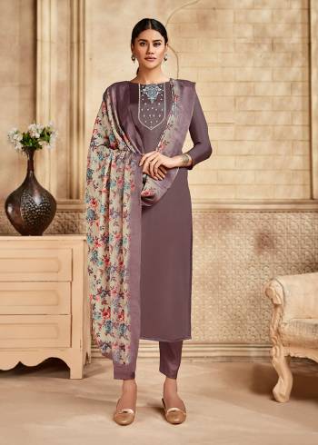 Here Is A Pretty Designer Straight Suit Suitable For The Upcoming Festive Season In This Lovely Mauve Color Paired With Multi Colored Dupatta. Its Top Is Fabricated On Saton Silk Beautified With Minimal Elegant Embroidery Paired With Santoon Bottom and Viscose Muslin Printed Dupatta. Buy this Pretty Suit Now.