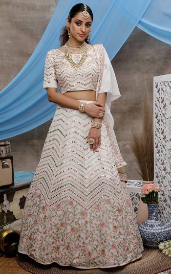 Here Is A Rich And Elegant Looking Designer Lehenga Choli In White Coolor. This Beautiful Detailed Embroidered Lehenga, Choli And Dupatta Are Fabricated On Georgette. Its Pretty Colors And Fabric Will Earn You Lots Of compliments From Onlookers. 