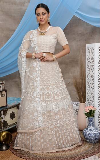 Look Pretty In This Lovely Designer Lehenga Choli In Cream Color. This Lehenga Choli Is Fabricated On Net Paired With Net Fabricated Dupatta. It Is Light In Weight and Easy To Carry Throughout The Gala. 