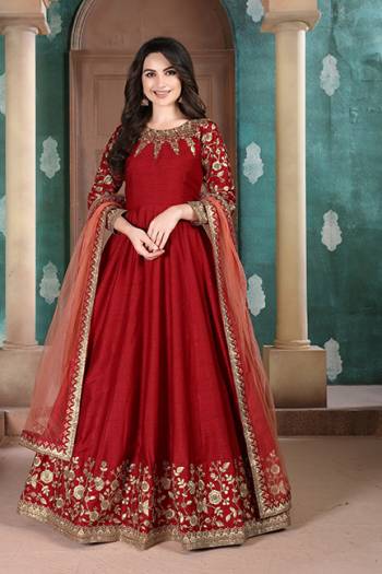 Here Is A Designer Floor Length Suit In Red Color Paired With Grey Colored Dupatta. Its Pretty Embroidered Top Is Fabricated on Slub Silk Paired With Santoon Bottom and Net Fabricated Dupatta. Buy Now.