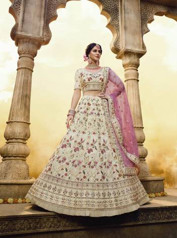 Rich And Elegant Looking Heavy Designer Lehenga Choli Is Here In Cream Color Paired With Pink Colored Dupatta. This Pretty Lehenga Choli Is Georgette Based Paired With Net Fabricated Dupatta. Buy Now.