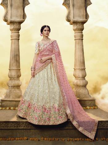 Elegant Looking Heavy Designer Lehenga Choli Is Here In Off-White Color Paired With Pink Colored Dupatta. This Lovely Contrasting Color Embroidered Lehenga And Choli Are Fabricated On Georgette Paired With Net Fabricated Dupatta. Buy Now.