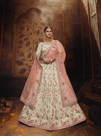 Elegant Looking Heavy Designer Lehenga Choli Is Here In Off-White Color Paired With Peach Colored Dupatta. This Lovely Contrasting Color Embroidered Lehenga And Choli Are Fabricated On Georgette Paired With Net Fabricated Dupatta. Buy Now.