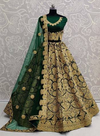 Here Is A Beautiful Heavy Embroidered Bridal Lehenga Choli In Dark Green Color. Its Heavy Embroidered Blouse and Lehenga Are Fabricated On Art Silk Paired With Net Fabricated Dupatta. 