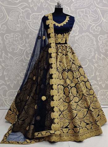 Here Is A Beautiful Heavy Embroidered Bridal Lehenga Choli In Navy Blue Color. Its Heavy Embroidered Blouse and Lehenga Are Fabricated On Art Silk Paired With Net Fabricated Dupatta. 