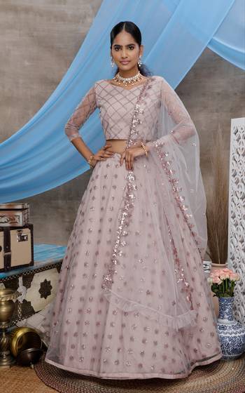 Here Is A Very Pretty Designer Lehenga Choli For The Upcoming Wedding Season In All Over Mauve Color. This Trendy Lehenga Choli Is Fabricated On Net Beautified With Heavy Yet Subtle Tone To Tone Embroidery. Buy This Lovely Piece Now.