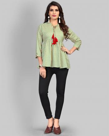 Here Is A Pretty Elegant Looking Readymade Top In Light Green Color Fabricated On Cotton Beautified With Prints. It Is Light In Weight And Can Be Paired With Denim Or Pants. 