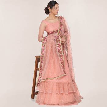 Here Is A Trendy Heavy Designer Lehenga Choli In Peach Color. This Beautiful Patterned Lehenga Choli And Dupatta Are Fabricated On Net and Has Quite Heavy Embroidery Over It. Buy Now. 