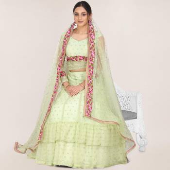 Get Ready For the Upcoming Wedding Season Wearing This Heavy Designer Lehenga Choli In Pastel Green Color. Its Blouse, Lehenga And Dupatta Are Fabricated On Net Beautified With Heavy Embroidery Work.