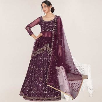 Here Is A Trendy Heavy Designer Lehenga Choli In Wine Color. This Beautiful Patterned Lehenga Choli And Dupatta Are Fabricated On Net and Has Quite Heavy Embroidery Over It. Buy Now. 