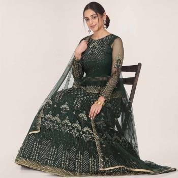 Get Ready For the Upcoming Wedding Season Wearing This Heavy Designer Lehenga Choli In Pine Green Color. Its Blouse, Lehenga And Dupatta Are Fabricated On Net Beautified With Heavy Embroidery Work.