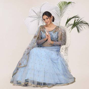 Add This Very Beautiful Heavy Designer Lehenga Choli To Your Wardrobe In Sky Blue color. This Pretty Lehenga, Choli And Dupatta Are Net Based Beautified With Embroidery.