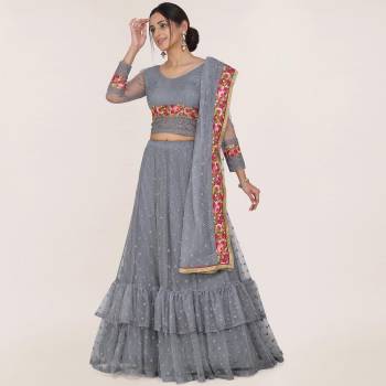 Here Is A Trendy Heavy Designer Lehenga Choli In Grey Color. This Beautiful Patterned Lehenga Choli And Dupatta Are Fabricated On Net and Has Quite Heavy Embroidery Over It. Buy Now. 