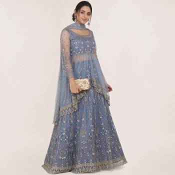 Get Ready For the Upcoming Wedding Season Wearing This Heavy Designer Lehenga Choli In Steel Blue Color. Its Blouse, Lehenga And Dupatta Are Fabricated On Net Beautified With Heavy Embroidery Work.