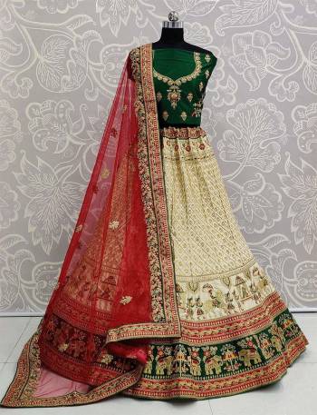 For A Proper Traditional Look, Grab This Heavy Designer Colorful Lehenga Choli In Green Colored Blouse Paired With Cream Colored Lehenga And Red Colored Dupatta. Its Heavy Embroidered Blouse And Lehenga Are Fabricated On Satin Paired With Net Fabricated Embroidered Dupatta. 