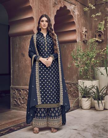 Enhance Your Personality Wearing This Heavy Designer Straight Suit In Navy Blue Color. Its Top Is Jacquard Silk Based Paired With Art Silk Fabricated Embroidered Bottom And Chiffon Dupatta. Its Rich Color and Fabric Will Earn You Lots Of Compliments From Onlookers. 