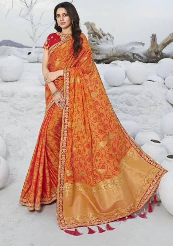 Catch All The Limelight At The Next Wedding You Attend Wearing This Designer Orange Colored Saree Paired With Contrasting Red Colored Blouse. This Saree Is Jacquard Silk Based Paired With Art Silk Fabricated Blouse. 