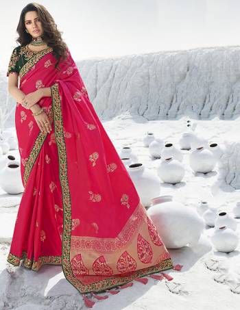 Look Attractive Wearing This Designer Saree In Rani Pink Color Paired with Contrasting Pine Green Colored Blouse. This Pretty Saree Is Fabricated On Jacquard Silk Paired With Art Silk Fabricated Embroidered Blouse. Its Rich Fabric And Color Pallete Will Earn You Lots Of Compliments From Onlookers. 