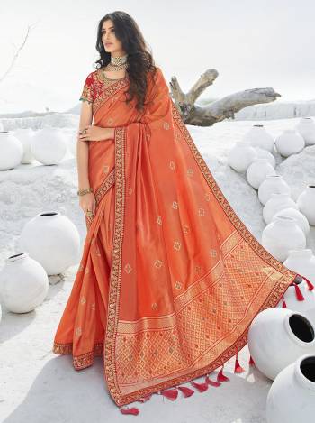 Look Attractive Wearing This Designer Saree In Orange Color Paired with Contrasting Red Colored Blouse. This Pretty Saree Is Fabricated On Jacquard Silk Paired With Art Silk Fabricated Embroidered Blouse. Its Rich Fabric And Color Pallete Will Earn You Lots Of Compliments From Onlookers. 