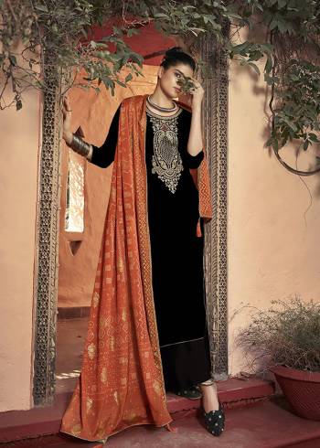 Get Ready For The Upcoming Wedding And Festive Season With This Trendy Designer straight Suit In Black Color Paired With Orange Colored Dupatta. Its Elegant Neck Embroidered Top Is Fabricated On Velvet Paired With Santoon Bottom and Chinon Fabricated Bandhani Print Dupatta. 