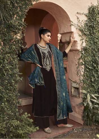 Get Ready For The Upcoming Wedding And Festive Season With This Trendy Designer straight Suit In Brown Color Paired With Blue Colored Dupatta. Its Elegant Neck Embroidered Top Is Fabricated On Velvet Paired With Santoon Bottom and Chinon Fabricated Bandhani Print Dupatta. 