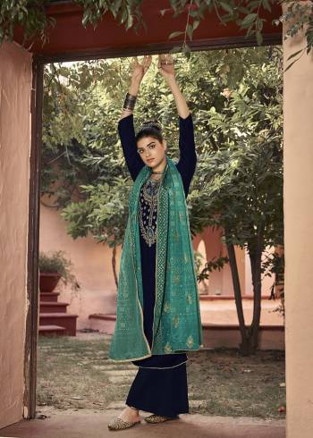 Look Attractive Wearing This New Pattenered Designer Straight Suit In Navy Blue Color Paired With Turquoise Blue Colored Dupatta. Its Top Is Fabricated On Velvet Paired With Santoon Bottom And Chinon Dupatta. Its Top Is Beautified With Neck Embroidery And Dupatta Has Pretty Badhani Prints. 