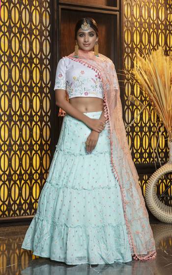 Look Pretty In This Subtle Color Pallete Lehenga Choli In White Colored Blouse Paired With Sky Blue Colored Lehenga And Peach Colored Dupatta. Its Blouse And Lehenga Are Cotton Based Paired With Net Fabricated Dupatta. 