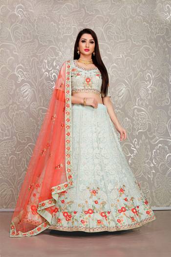 Flaunt Your Rich And Elegant Taste Wearing This Pretty Baby Blue Colored Lehenga Choli Paired With Orange Colored Dupatta. Its Blouse And Lehenga Are Fabricated On Georgette Paired With Net Fabricated Dupatta. 