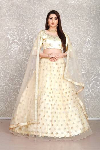 Simple And Elegant Looking Designer Lehenga Choli Is Here In All Over Cream Color. This Lehenga Choli IS Net Based Beautified With Pretty Attractive Embroidered Buttis. 