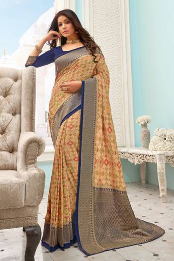 Flaunt Your Rich And Elegant Taste Wearing This Designer Printed Saree In Beige Color Paired With Navy Blue Colored Blouse. This Saree And Blouse Are Fabricated On Handloom Silk Beautified With Prints and Weaved Broad Border. 