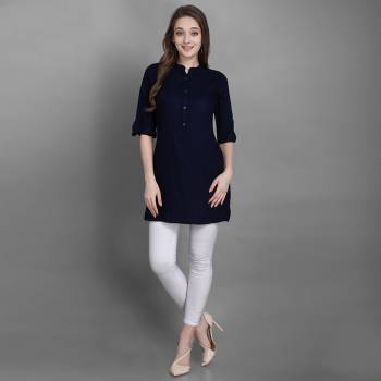 Here Is A Simple And Elegant Looking Readymade Short Kurti For Your Casual Wear In Navy Blue Color. This Plain Kurti Is Fabricated On Rayon , Available In All Regular Sizes. It Can Be Paired With Pants, Leggings Or Denim. 