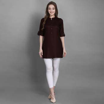 Here Is A Simple And Elegant Looking Readymade Short Kurti For Your Casual Wear In Brown Color. This Plain Kurti Is Fabricated On Rayon , Available In All Regular Sizes. It Can Be Paired With Pants, Leggings Or Denim. 