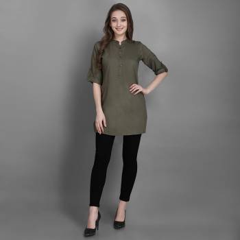 Here Is A Simple And Elegant Looking Readymade Short Kurti For Your Casual Wear In Olive Green Color. This Plain Kurti Is Fabricated On Rayon , Available In All Regular Sizes. It Can Be Paired With Pants, Leggings Or Denim. 