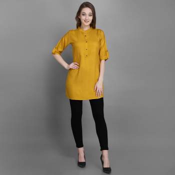 Here Is A Simple And Elegant Looking Readymade Short Kurti For Your Casual Wear In Yellow Color. This Plain Kurti Is Fabricated On Rayon , Available In All Regular Sizes. It Can Be Paired With Pants, Leggings Or Denim. 