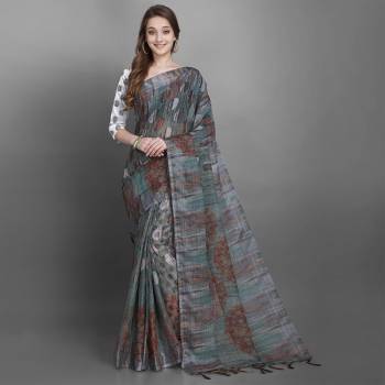 You Will Definitely Earn Lots Of Compliments Wearing This Pretty Saree In Grey Color Paired With White Colored Blouse. This Saree And Blouse Are Fabricated On Linen Slub Beautified With Prints. 