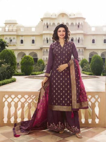 Here Is A Very Pretty Designer Straight Suit In Wine Color. Its Top And Dupatta Are Fabricated On Jacquard Silk Paired With Art Silk Fabricated Bottom. It Is Beautified With Weave And Embroidery. Also Its Rich Fabric And Color Will Definitely Earn You Lots Of Compliments From Onlookers. 