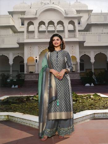 Flaunt Your Rich And Elegant Taste Wearing This Designer Straight Suit In Grey Color. This Pretty Top And Dupatta Are Fabricated On Jacquard Silk Paired With Art Silk Fabricated Bottom. Buy This Semi-Stitched Suit Now.