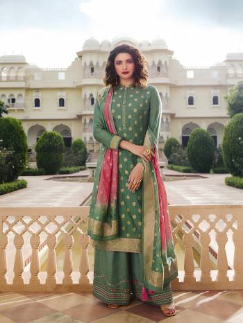 Here Is A Very Pretty Designer Straight Suit In Light Green Color. Its Top And Dupatta Are Fabricated On Jacquard Silk Paired With Art Silk Fabricated Bottom. It Is Beautified With Weave And Embroidery. Also Its Rich Fabric And Color Will Definitely Earn You Lots Of Compliments From Onlookers. 