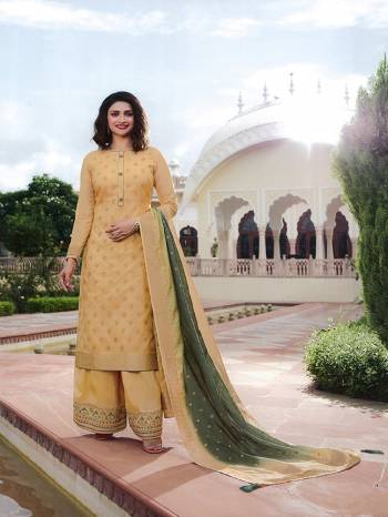 Here Is A Very Pretty Designer Straight Suit In Cream Color. Its Top And Dupatta Are Fabricated On Jacquard Silk Paired With Art Silk Fabricated Bottom. It Is Beautified With Weave And Embroidery. Also Its Rich Fabric And Color Will Definitely Earn You Lots Of Compliments From Onlookers. 