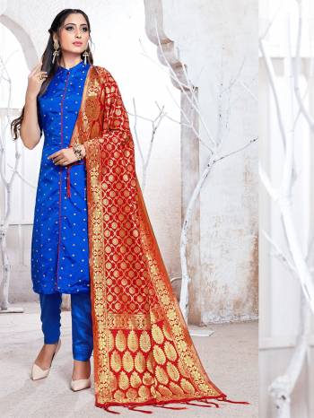 Celebrate This Festive Season In A Proper Traditional Look Wearing This Weaved Straight Suit In Royal Blue Color Paired with Red Colored Dupatta. This Pretty Suit Is Fabricated On Banarasi Silk Beautified With Weave. 