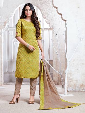 Flaunt Your Rich And Elegant Taste Wearing This Pretty Light Green And Beige Colored Straight Suit. Its Top, Bottom And Dupatta Are Fabricated On Cotton Silk Which Gives A Rich Look To Your Personality. 