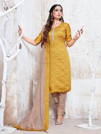 Flaunt Your Rich And Elegant Taste Wearing This Pretty Musturd Yellow And Beige Colored Straight Suit. Its Top, Bottom And Dupatta Are Fabricated On Cotton Silk Which Gives A Rich Look To Your Personality. 