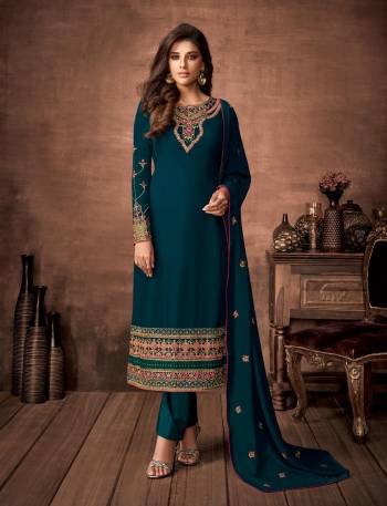 Here Is A Very Pretty Designer Straight Suit In Teal Blue Color. Its Embroidered Top and Dupatta Are Fabricated On Georgette Paired with Santoon Fabricated Bottom. Its Fabrics Are Soft Towards Skin And Esnures Superb Comfort All Day Long. 