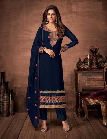 Here Is A Very Pretty Designer Straight Suit In Navy Blue Color. Its Embroidered Top and Dupatta Are Fabricated On Georgette Paired with Santoon Fabricated Bottom. Its Fabrics Are Soft Towards Skin And Esnures Superb Comfort All Day Long. 