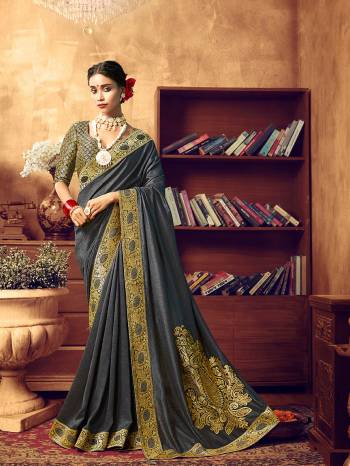 Adorn A Beautiful Angelic Look Wearing This Designer Saree In Dark Grey Color. This pretty Embroidered Saree Is Fabricated On Art Silk Paired With Jacquard Silk Fabricated Heavy Weaved Blouse. Its Attractive Color and Rich Fabric Will Earn You Lots Of Compliments From Onlookers. 