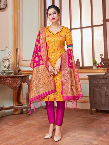 Celebrate This Festive Season In A Proper Traditional Look Wearing This Weaved Straight Suit In Musturd Yellow Colored Top Paired With Contrasting Dark Pink Colored Bottom And Dupatta. This Pretty Suit Is Banarasi Silk Based Beautified With Weave. Its Fabric Gives A Rich Look To Your Personality. 